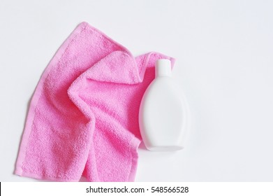 Pink Terry Towel And Bottle Of Shampoo Or Shower Gel. Bath Products Photo, Flat Lay, Top View