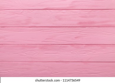 Pink texture of a wooden table. Pastel coloured background. 
