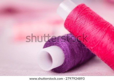Pink thread spool on white surface, sewing, thread, crafting