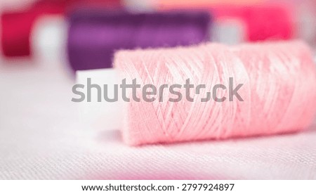Pink thread spool on white surface, sewing, thread, crafting