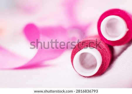 Pink thread spool on white surface, sewing, thread, crafting