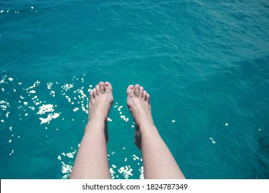 Pink Toenails With Turquoise Water