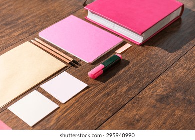 Pink tools prepared on wooden desk office for paperwork