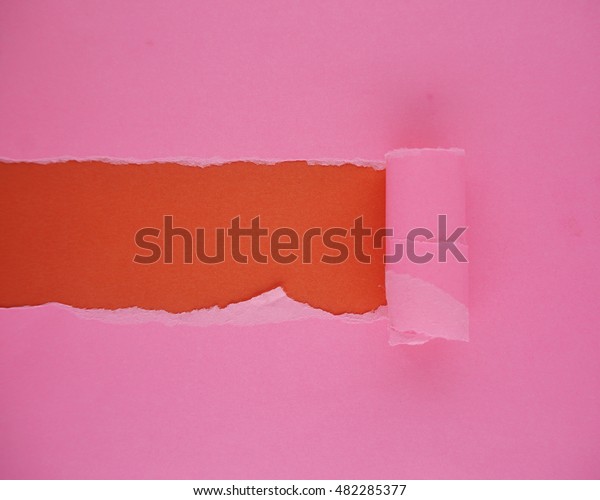 Pink torn paper with space for text. Pink torn\
paper on red background