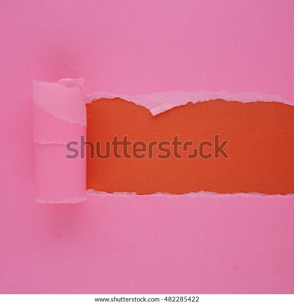 Pink torn paper with space for text. Pink torn\
paper on red background
