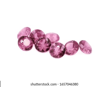Pink tourmaline diamond cut gems on a white background.