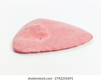 Pink triangular tailor's chalk isolated on white background.