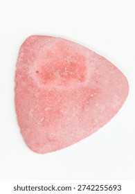 Pink triangular tailor's chalk isolated on white background.