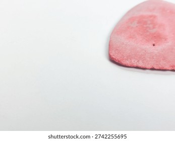 Pink triangular tailor's chalk isolated on white background.