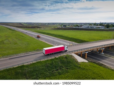 Pink Truck With Cargo Semi Trailer Moving On Road In Direction. Highway Intersection Junction. Aerial Top View