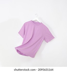 Pink tshirt with hanger. Flying cotton T-shirt isolated on white background. - Shutterstock ID 2095631164