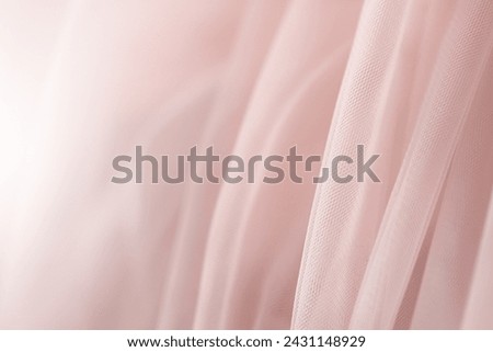 Pink tulle. Fashion design concept. Garment industry. Selective focus. Fabric background with folds