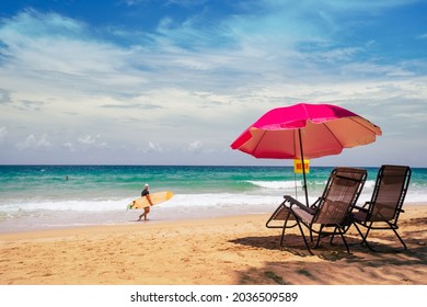 Pink Umbrella two chairs shoreline island Brazil. Surfboard person tropical seaside summer Italy. Landscape wide Blue sea sky travel trips famous beach Spain.