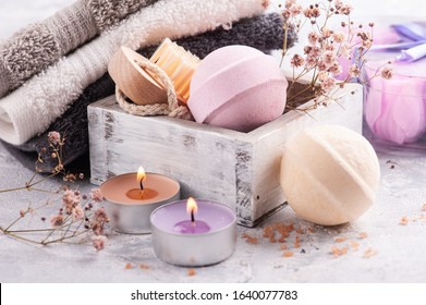 Pink Vanilla Aroma Bath Bombs In SPA Arrengement With Dry Flowers And Lit Candle 