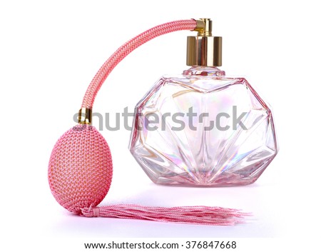 Pink vintage perfume bottle with atomizer isolated on white background.