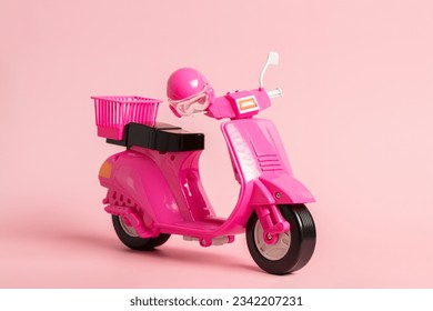 Pink vintage toy doll scooter or motorbike with helmet on pastel pink background. 80s, clsssic, retro style