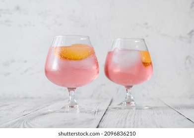 Pink Vodka Lemonade Cocktail Garnished With Lemon Wedge