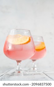 Pink Vodka Lemonade Cocktail Garnished With Lemon Wedge