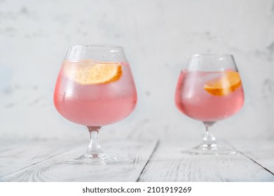 Pink Vodka Lemonade Cocktail Garnished With Lemon Wedge