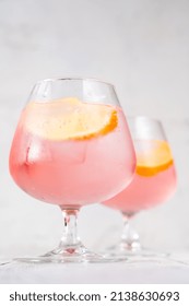 Pink Vodka Lemonade Cocktail Garnished With Lemon Wedge