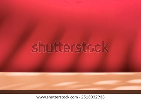Pink wall background and empty table space. Composition with abstract shadows. Mockup for presentation, branding products, cosmetics, food or jewelry. Premium light background