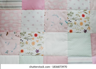 Pink Warm Patchwork Blanket Top View.  Cozy Baby Girl Cot With Blanket. Bedding And Textile For Children Nursery. Nap And Sleep Time Concept