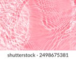 Pink water waves on the surface ripples blurred. Defocus blurred transparent blue colored clear calm water surface texture with splash and bubbles. Water waves with shining pattern texture background.