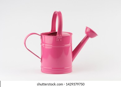 
Pink watering can isolated on a white background.