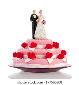 Pink Wedding Cake With Red Roses And Couple On Top