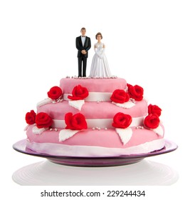 Pink Wedding Cake With Red Roses And Couple On Top