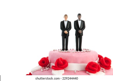 Pink wedding cake with red roses and gay couple on top