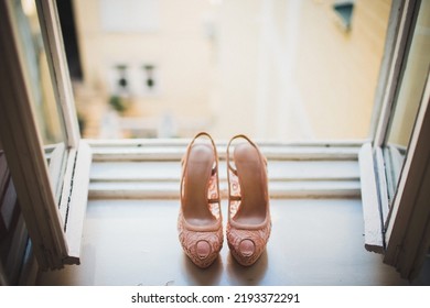 Pink Wedding Shoes On A Wooden Windowsill.