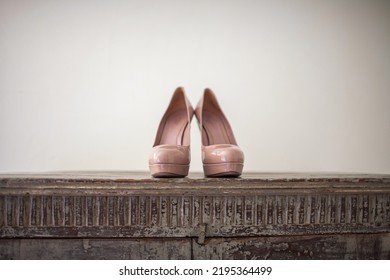 Pink Wedding Shoes On A Wooden Windowsill.