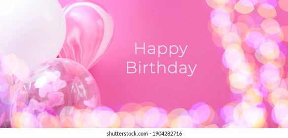 Pink and white balloons with helium on a pink background with bokeh lights, banner with with text Happy birthday