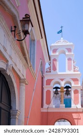 The pink and white belltower of agios triada in gaios, paxos, ionian islands, greek islands, greece, europe