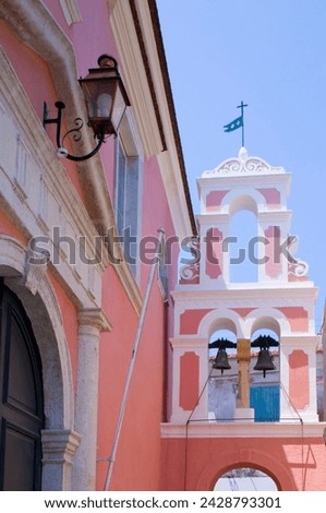 The pink and white belltower of agios triada in gaios, paxos, ionian islands, greek islands, greece, europe