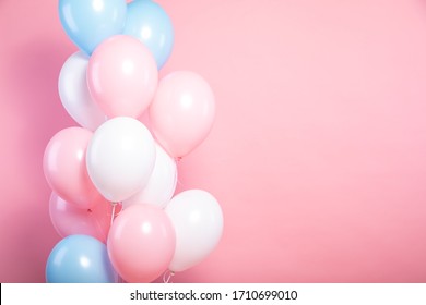 Pink, White And Blue Balloons On A Pink Background.