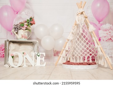 pink and white decoration for a 1st birthday cake smash studio photo shoot with balloons, paper decor, cake and topper. High quality photo
