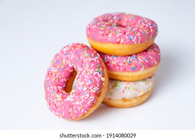 Pink and white doughnuts close up on a white background. High quality photo