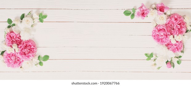 pink and white roses on white wooden background