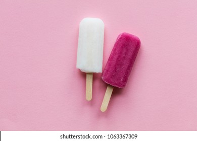 pink and white summer ice lollies on a pink background