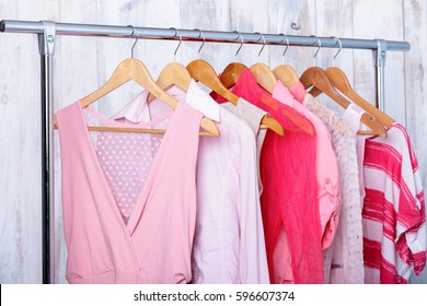 Pink Womens Clothes On Hangers On Rack In Fashion Store. Closet 