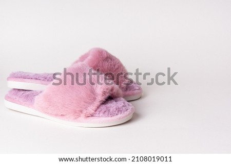 Pink women's home slippers on light background. Comfortable shoes for home. Space for text
