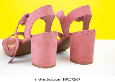 Pink Women`s Summer Sandals On A Yellow Background. Sustainable Heels Close-up. Comfortable Shoes.