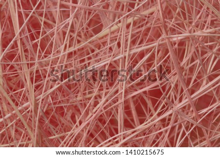 Pink wood fiber packaging material as background, close-up, high contrast, bright color.
