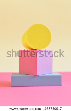 Pink and yellow abstract background with three-dimensional geometric shapes in pastel colors. Selective focus, space for text
