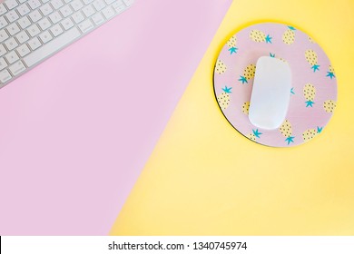 Pink & Yellow Desk Flat Lay With Mouse, Keyboard And Pineapple Mouse Pad