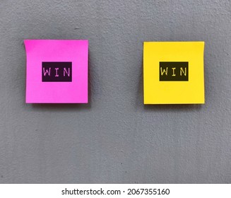 Pink And Yellow Note On Dirty Grey Wall With Text WIN WIN, Means A Situation Which Each Party Benefits In Some Way, Good For Everyone That Is Involved, Accept Negotiation Offer With No Losers