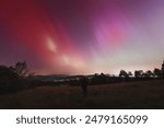 Pink, yellow and red aurora dancing over the Czech Republic. A great solar storm. Night sky under a geomagnetic storm turning pink. A miracle in the Czech Republic. Northern lights.