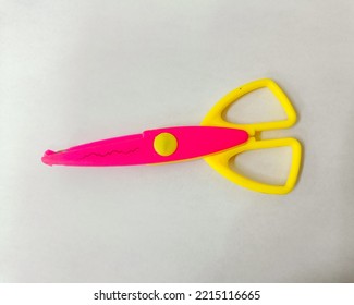 The Pink And Yellow Scissors For.cutting Paper